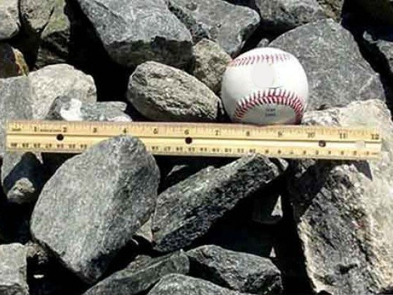 Gabion stone with a baseball and ruler for size, delivered in MD and VA