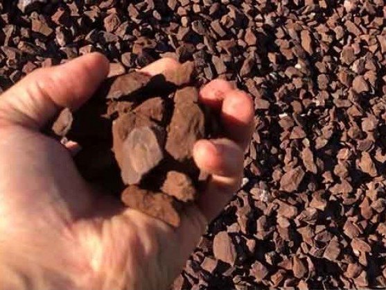 Red 3/4 inch decorative #57 gravel in a hand, delivered in MD and VA
