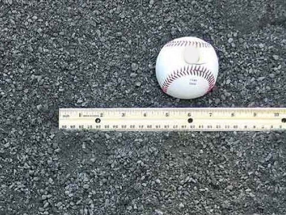 Stone dust with a baseball and ruler for size, delivered in MD and VA