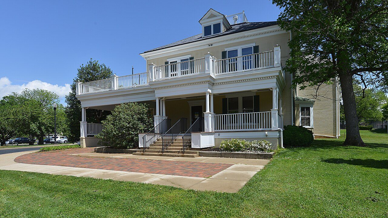 Gaithersburg City Hall, a restored 1895 house with a wraparound porch and lawn