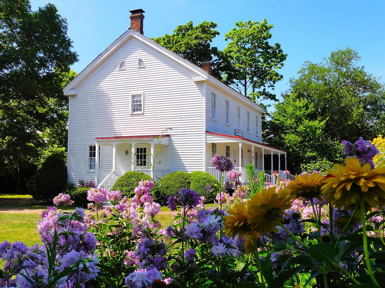 Historic Freeman House and Store on Church Street in Vienna with summer flowers