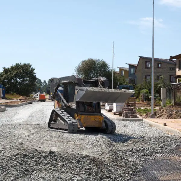 construction of a new street. mini excavator bobcat mowing breakstone