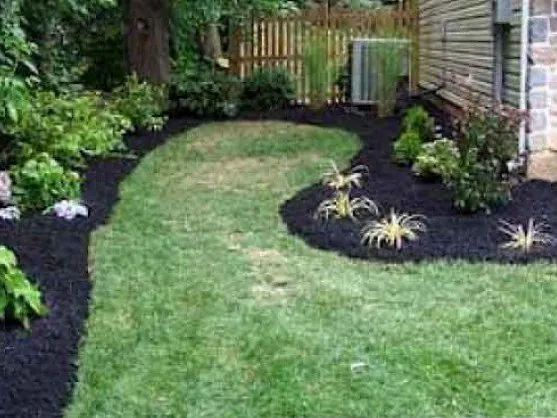 Backyard landscape beds finished with black mulch