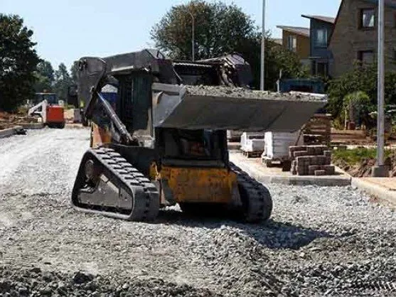 Skid steer spreading crush and run gravel