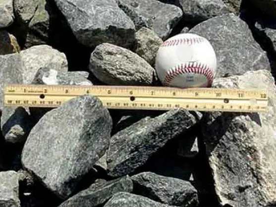 Gabion stone with a baseball and ruler for size, delivered in MD and VA
