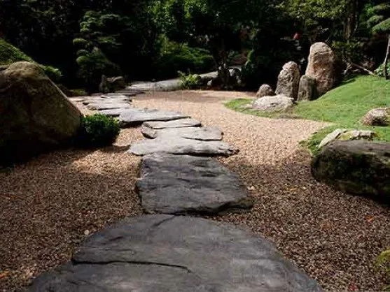 Pea gravel with stepping stones in a landscaped garden