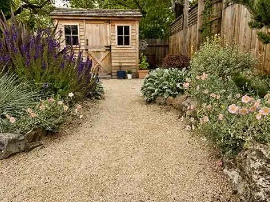 Pea gravel walkway through a cottage garden