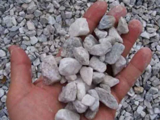 White 3/4 inch gravel stones in a hand